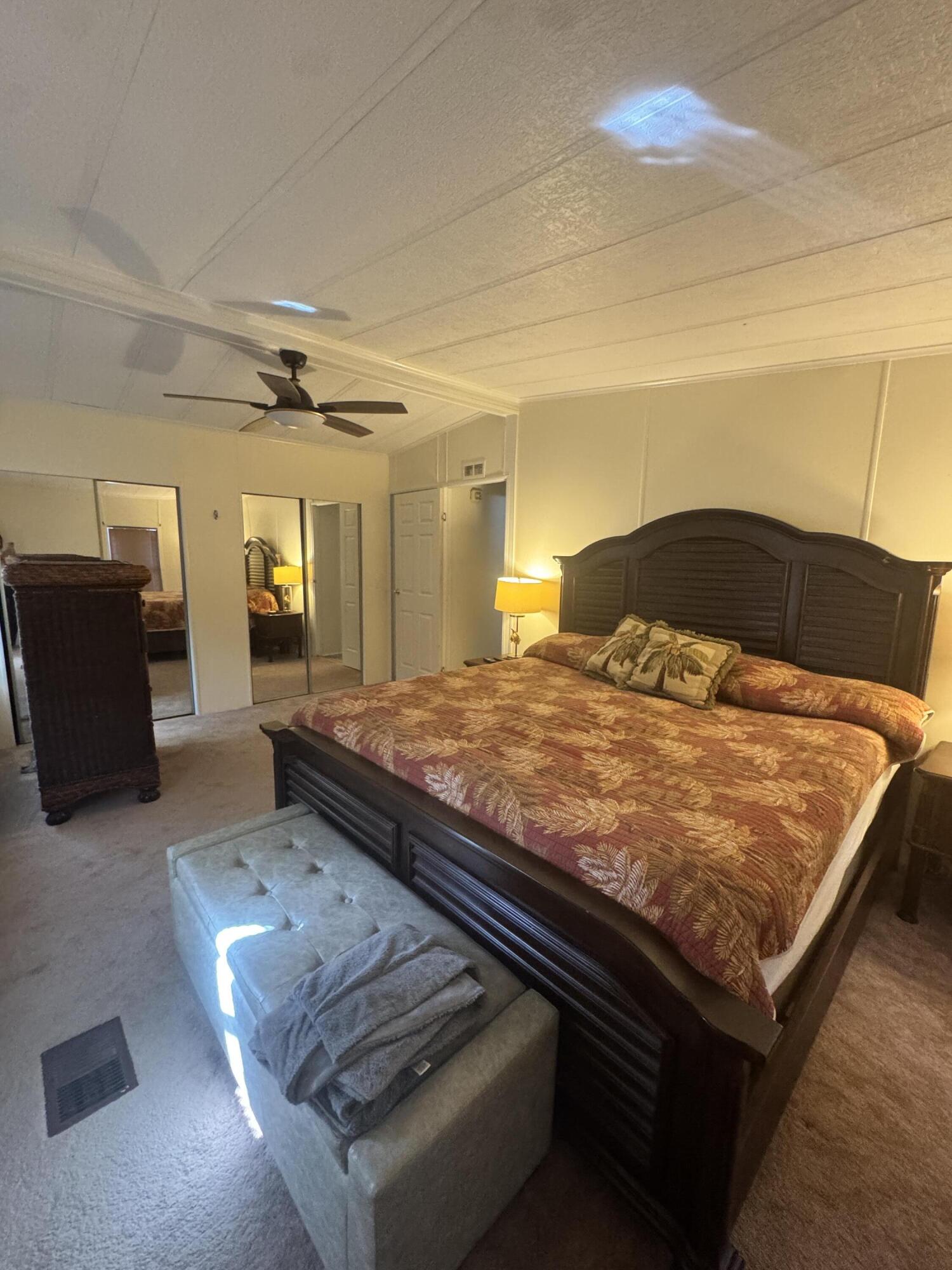 9 San Felipe Fort Pierce, FL 34951 - Photo 27 of 36 a bed sitting in a spacious bedroom next to a larger window