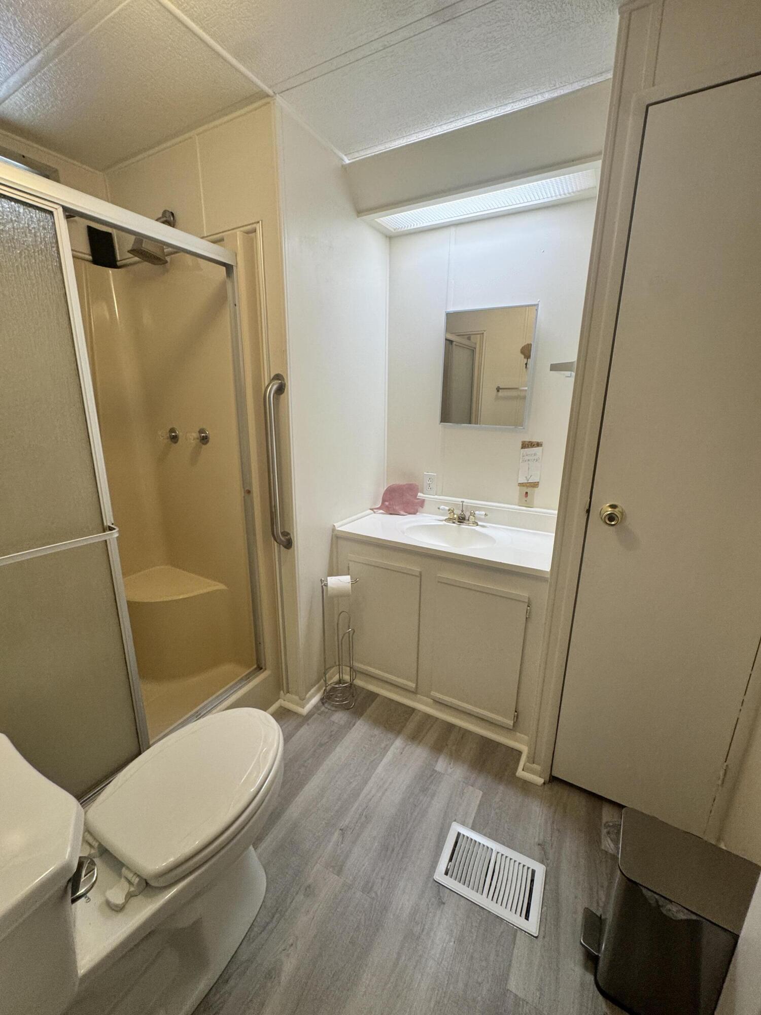 9 San Felipe Fort Pierce, FL 34951 - Photo 28 of 36 a bathroom with a sink mirror vanity and toilet