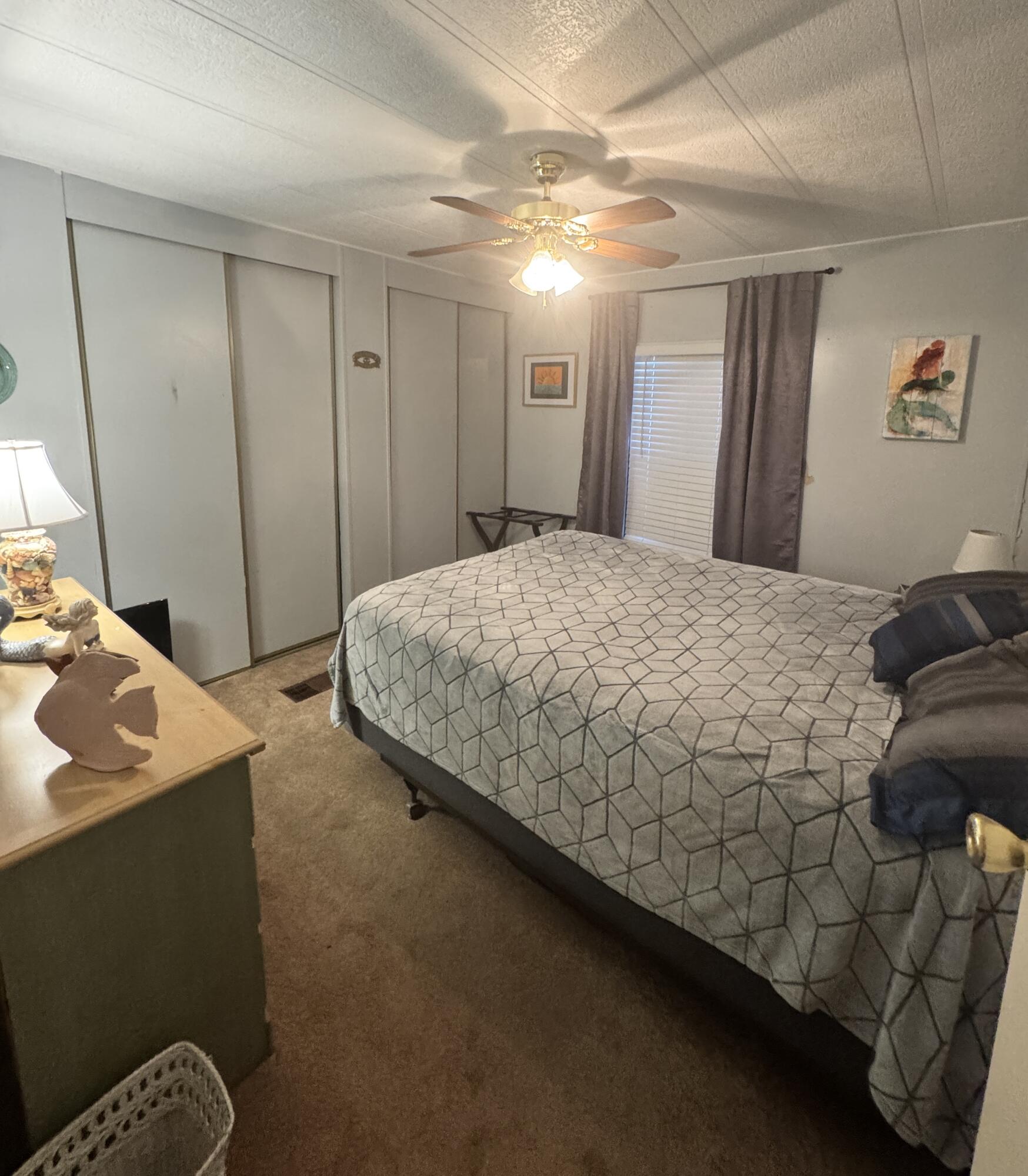 9 San Felipe Fort Pierce, FL 34951 - Photo 30 of 36 a bedroom with a bed and a mirror