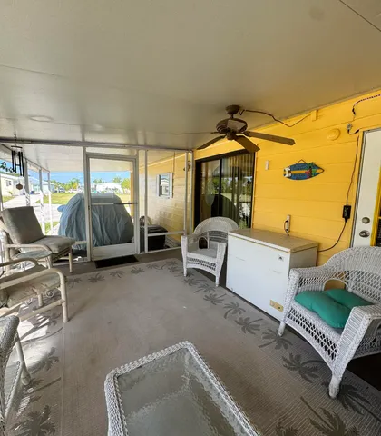 a view of a patio with table and chairs with wooden floor and seating space