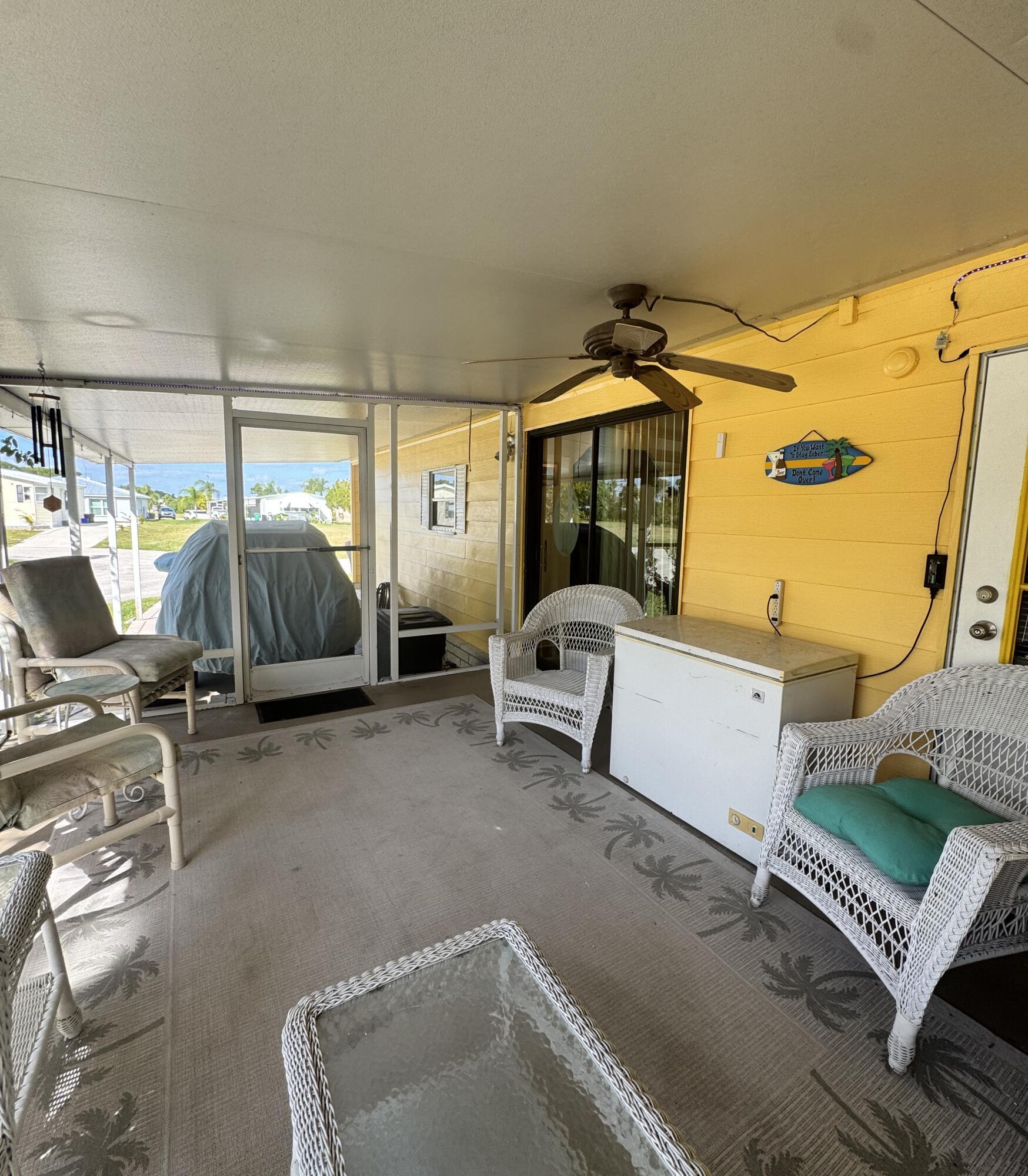 9 San Felipe Fort Pierce, FL 34951 - Photo 32 of 36 a view of a patio with table and chairs with wooden floor and seating space