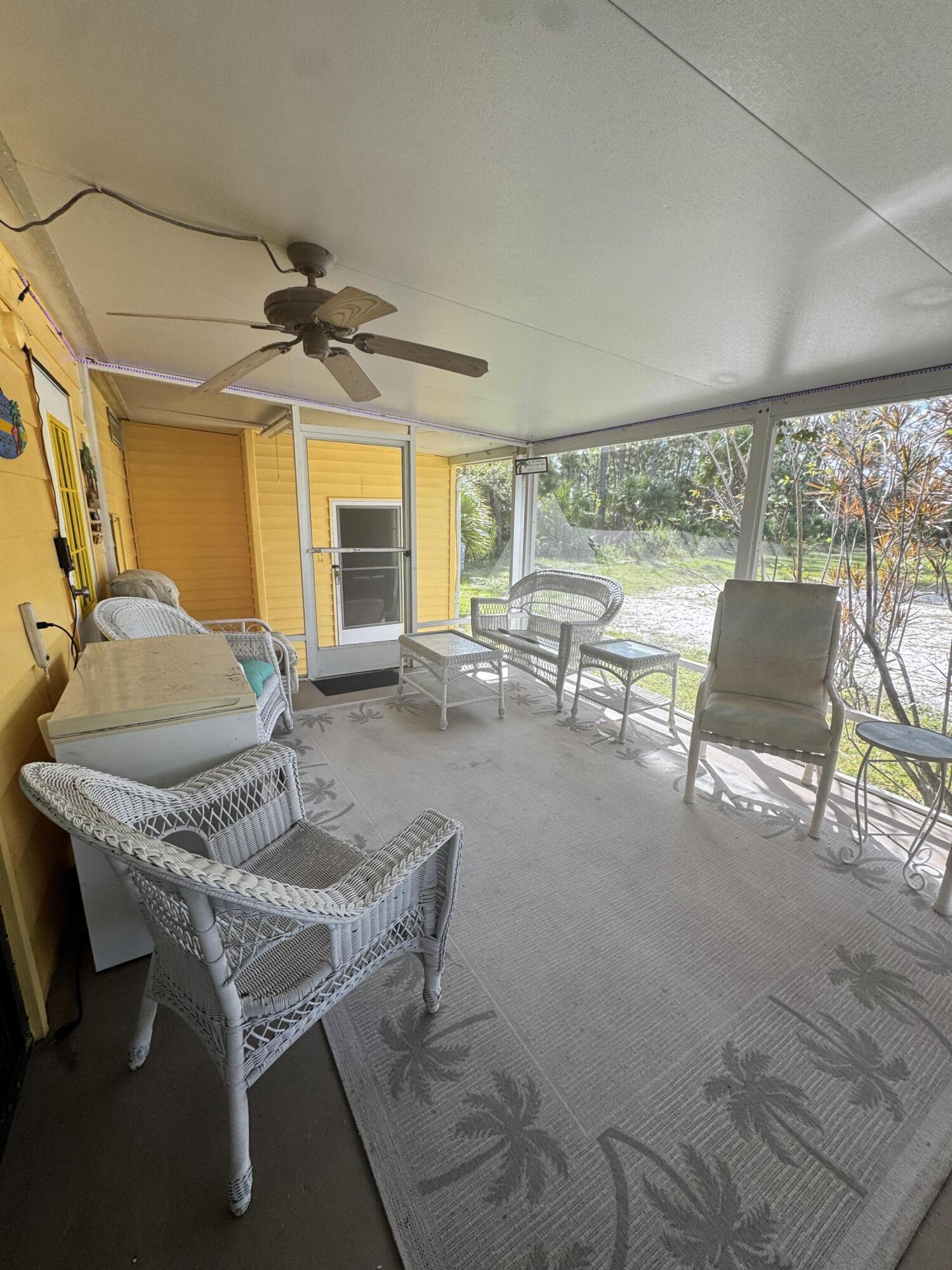 9 San Felipe Fort Pierce, FL 34951 - Photo 33 of 36 a living room with furniture a flat screen tv and a large window