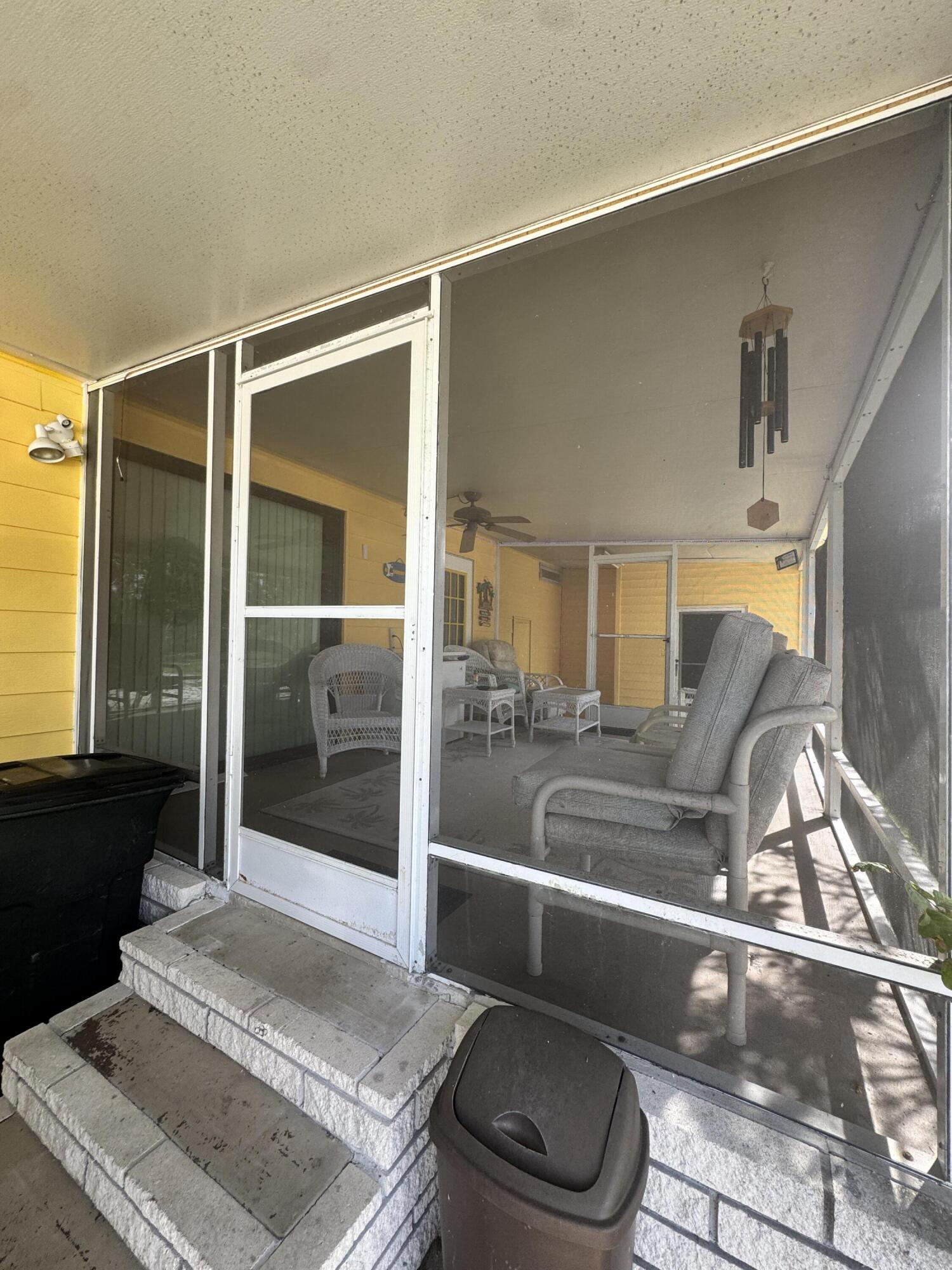 9 San Felipe Fort Pierce, FL 34951 - Photo 34 of 36 a living room with furniture and a floor to ceiling window