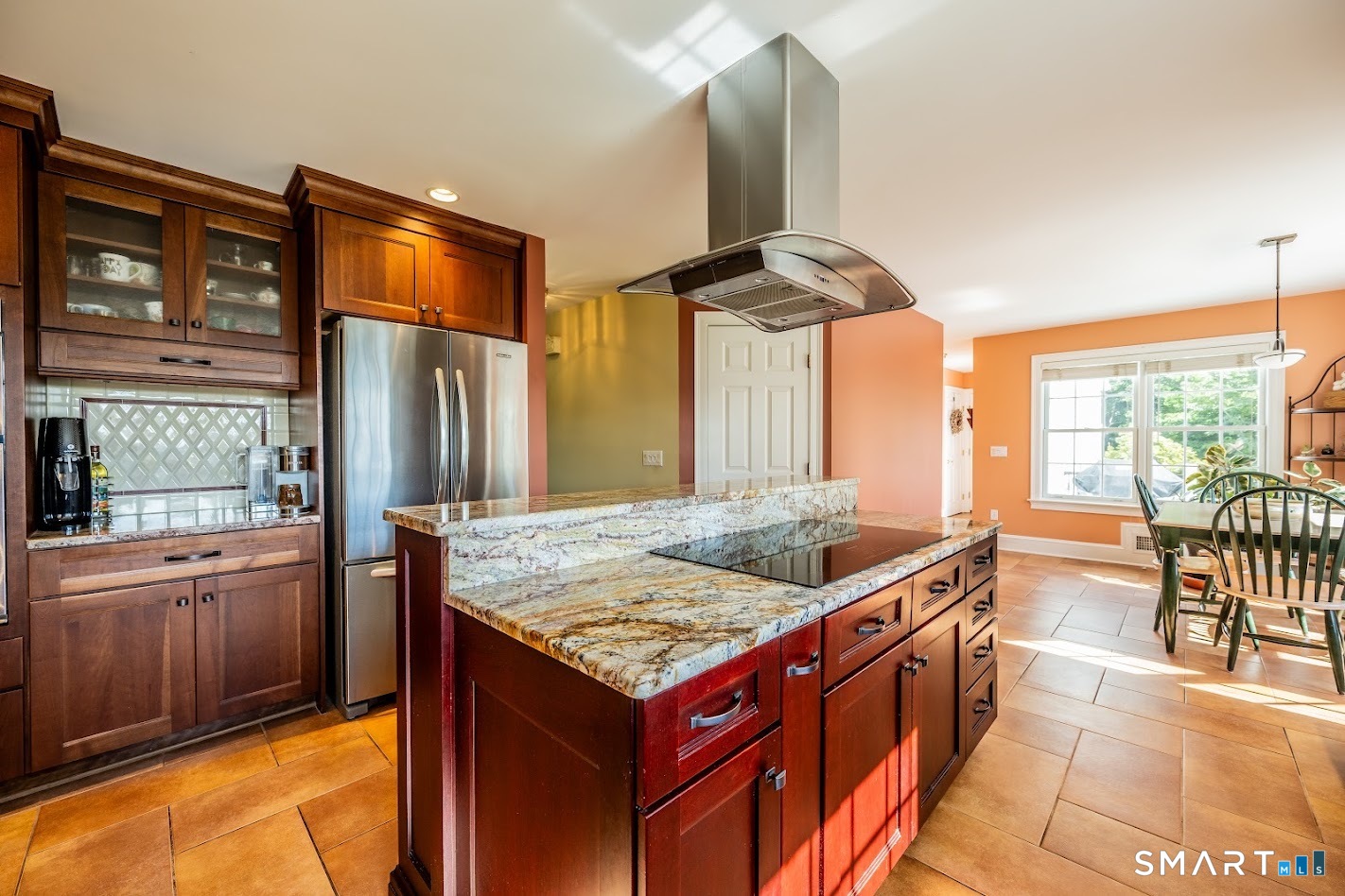 35 Anderson Lane Durham, CT 06422 - Photo 7 of 25 Spacious eat-in kitchen featuring an oversized granite island with cooktop, custom cherry cabinetry, stainless steel appliances, and a sun-filled dining area.