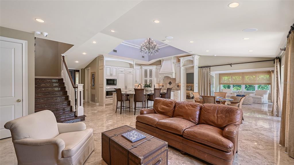 725 Penfield Street Longboat Key, FL 34228 - Photo 12 of 33 a living room with furniture potted plant and a large window