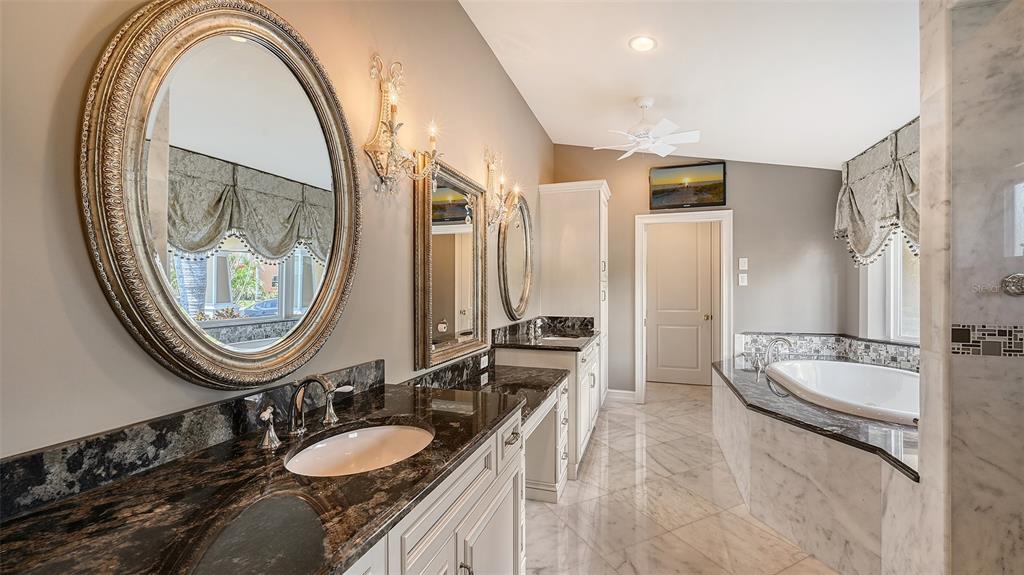 725 Penfield Street Longboat Key, FL 34228 - Photo 15 of 33 a bathroom with a double vanity sink and a mirror