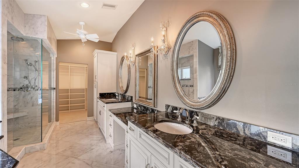 725 Penfield Street Longboat Key, FL 34228 - Photo 16 of 33 a spacious bathroom with a double vanity sink a mirror and a shower