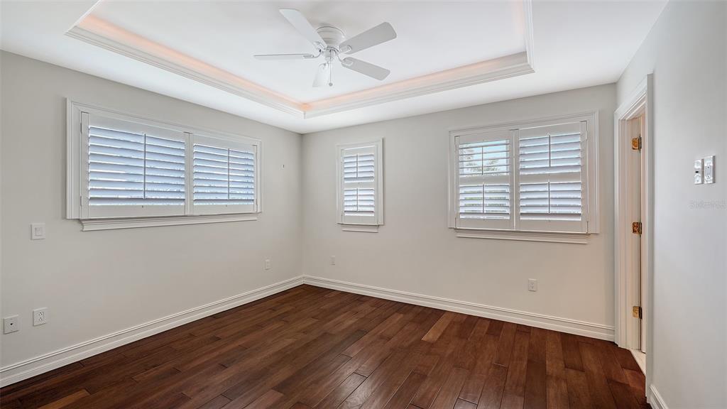 725 Penfield Street Longboat Key, FL 34228 - Photo 25 of 33 a view of an empty room with wooden floor and a window
