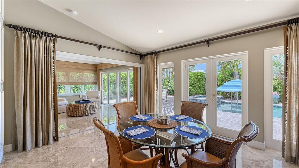 725 Penfield Street Longboat Key, FL 34228 - Photo 10 of 33 a view of a dining room with furniture large windows and wooden floor