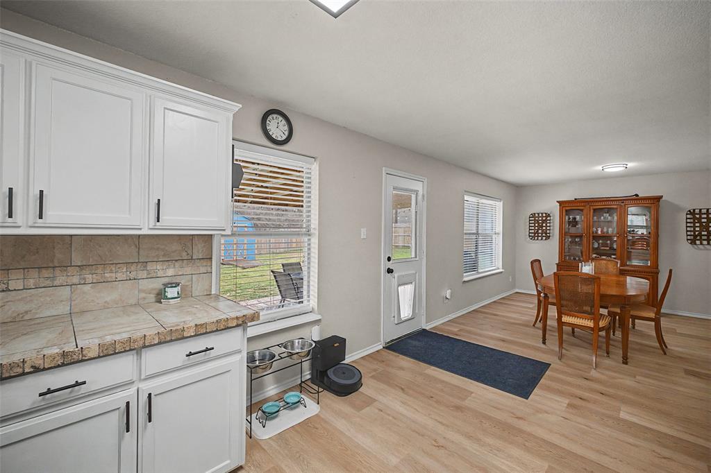 323 Sage Trail Springtown, TX 76082 - Photo 15 of 32 a open kitchen with stainless steel appliances granite countertop a refrigerator and wooden cabinets