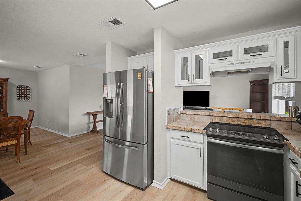 323 Sage Trail Springtown, TX 76082 - Photo 16 of 32 a kitchen with a stove and a refrigerator