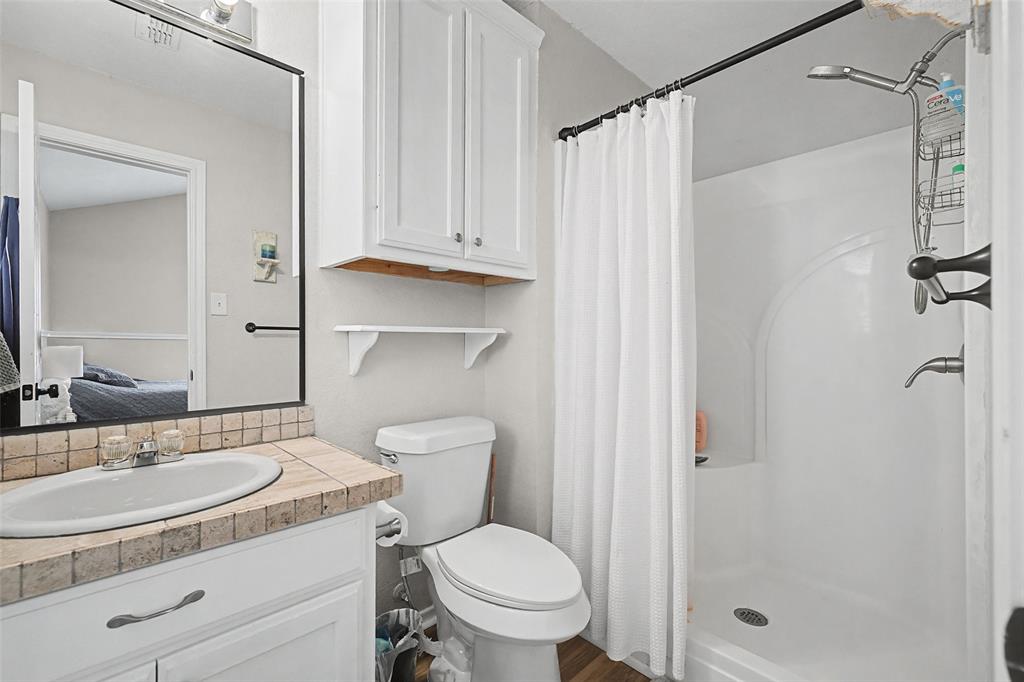 323 Sage Trail Springtown, TX 76082 - Photo 22 of 32 a bathroom with a sink toilet and shower