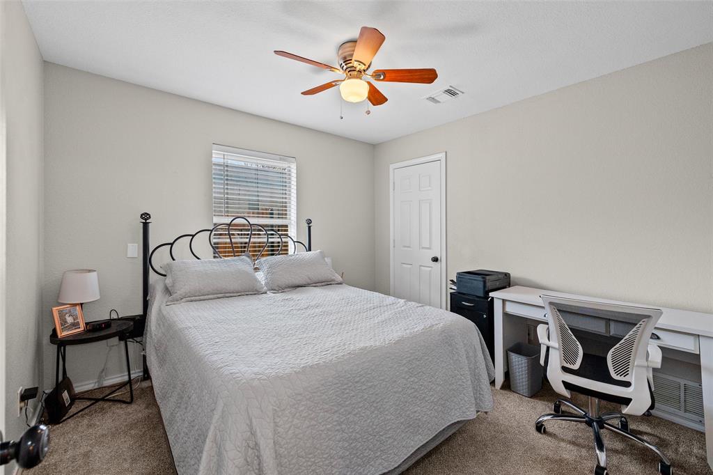 323 Sage Trail Springtown, TX 76082 - Photo 23 of 32 a bedroom with a bed and a chandelier