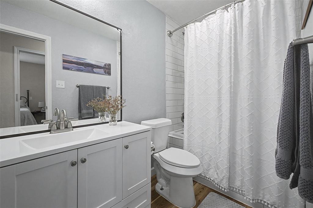 323 Sage Trail Springtown, TX 76082 - Photo 24 of 32 a bathroom with a toilet a sink and a mirror