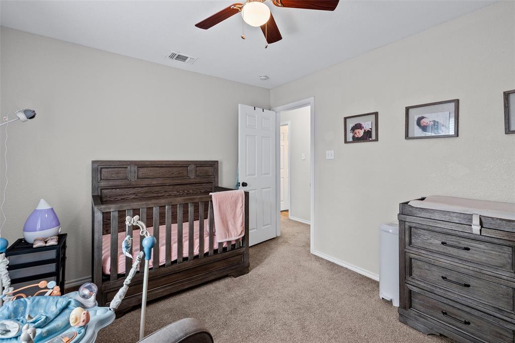 323 Sage Trail Springtown, TX 76082 - Photo 26 of 32 a bedroom with furniture and a chandelier