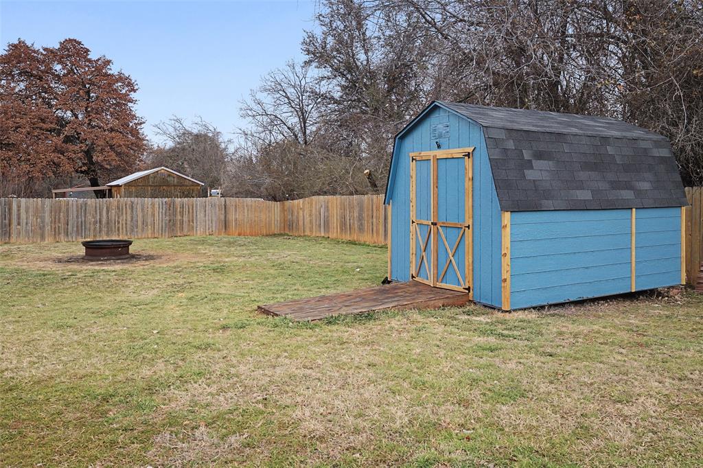 323 Sage Trail Springtown, TX 76082 - Photo 31 of 32 a front view of a house with a yard and garage