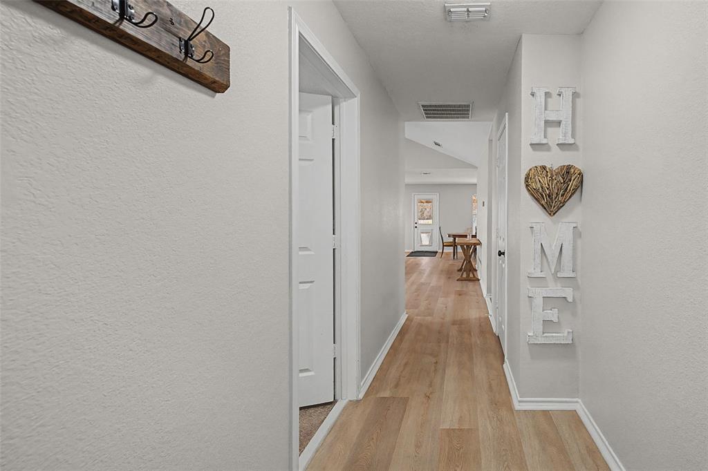 323 Sage Trail Springtown, TX 76082 - Photo 6 of 32 a view of a hallway with wooden floor