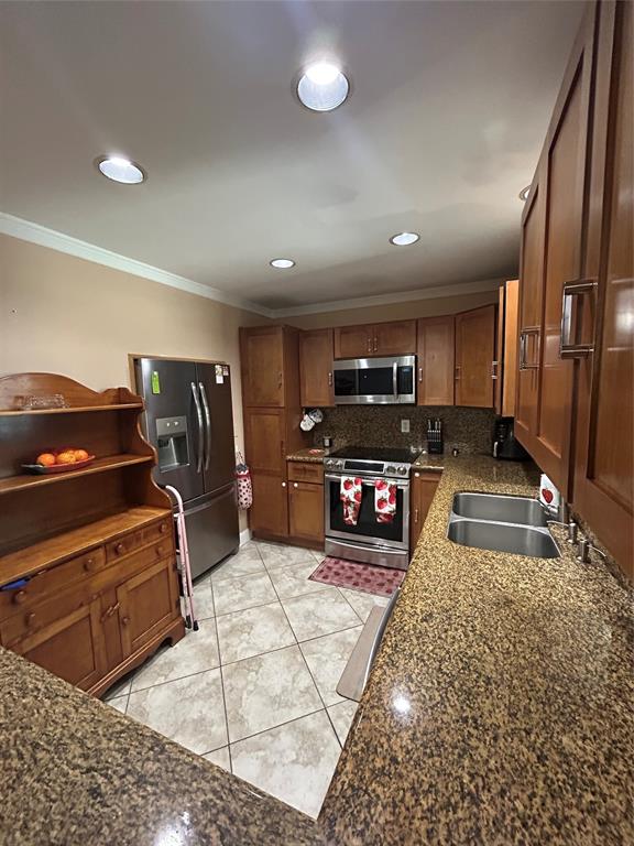 9548 Richmond Circle Boca Raton, FL 33434 - Photo 22 of 38 a kitchen with stainless steel appliances granite countertop a stove a sink and a microwave
