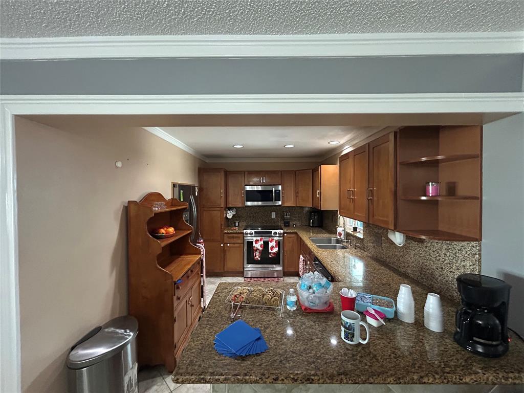 9548 Richmond Circle Boca Raton, FL 33434 - Photo 24 of 38 a kitchen with a refrigerator and a sink