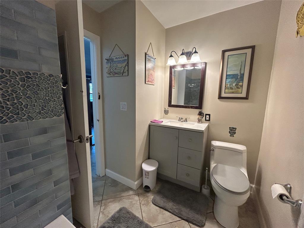 9548 Richmond Circle Boca Raton, FL 33434 - Photo 29 of 38 a bathroom with a toilet sink and mirror
