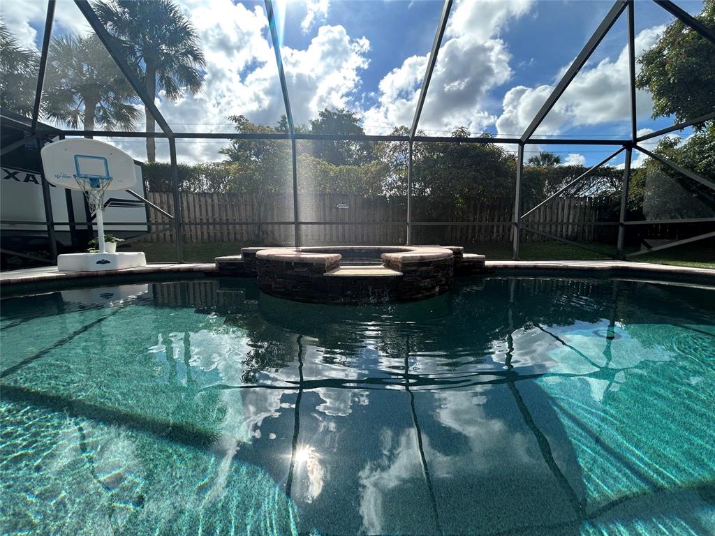 9548 Richmond Circle Boca Raton, FL 33434 - Photo 8 of 38 a swimming pool view with a couple of people