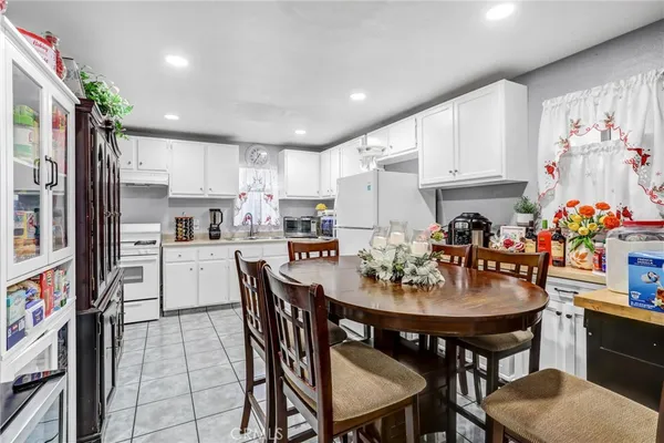 a kitchen with refrigerator and cabinets