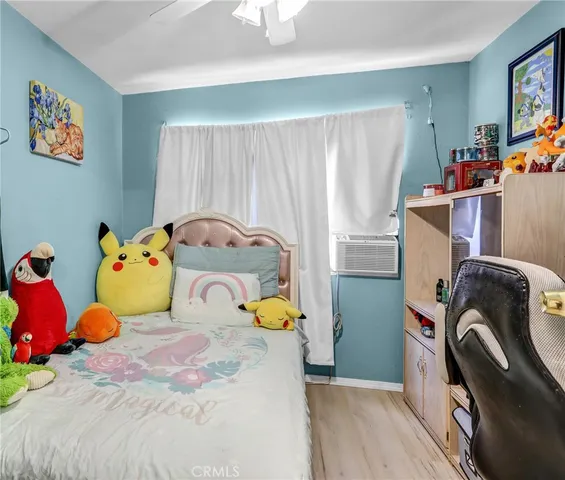 a bed sitting in a bedroom next to a window