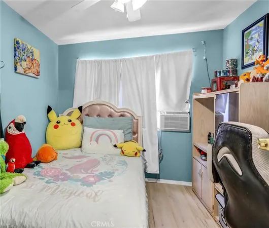 a bed sitting in a bedroom next to a window