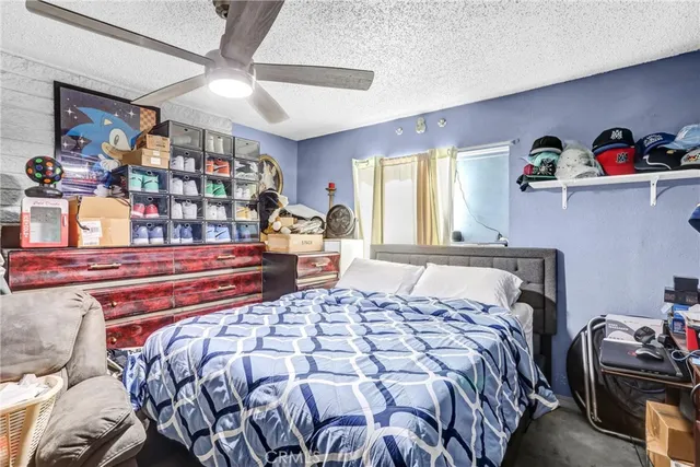 a bedroom with a bed and a large mirror