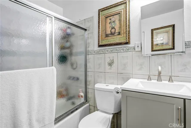 a view of a kitchen with fridge and workspace