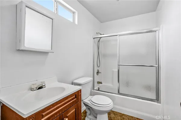 a bedroom with a bed and a ceiling fan