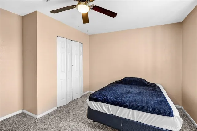 a room with furniture and a ceiling fan
