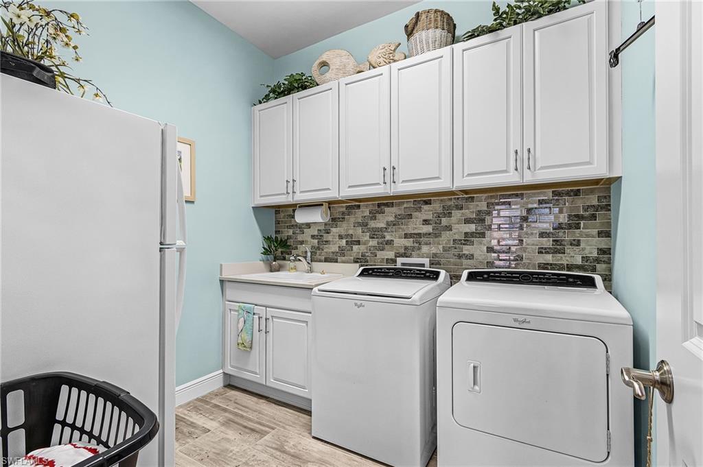 1434 Redona Way Naples, FL 34113 - Photo 11 of 47 a utility room with dryer and washer