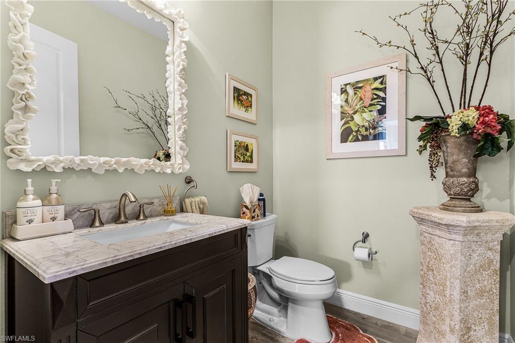 1434 Redona Way Naples, FL 34113 - Photo 12 of 47 a bathroom with a granite countertop toilet sink and mirror