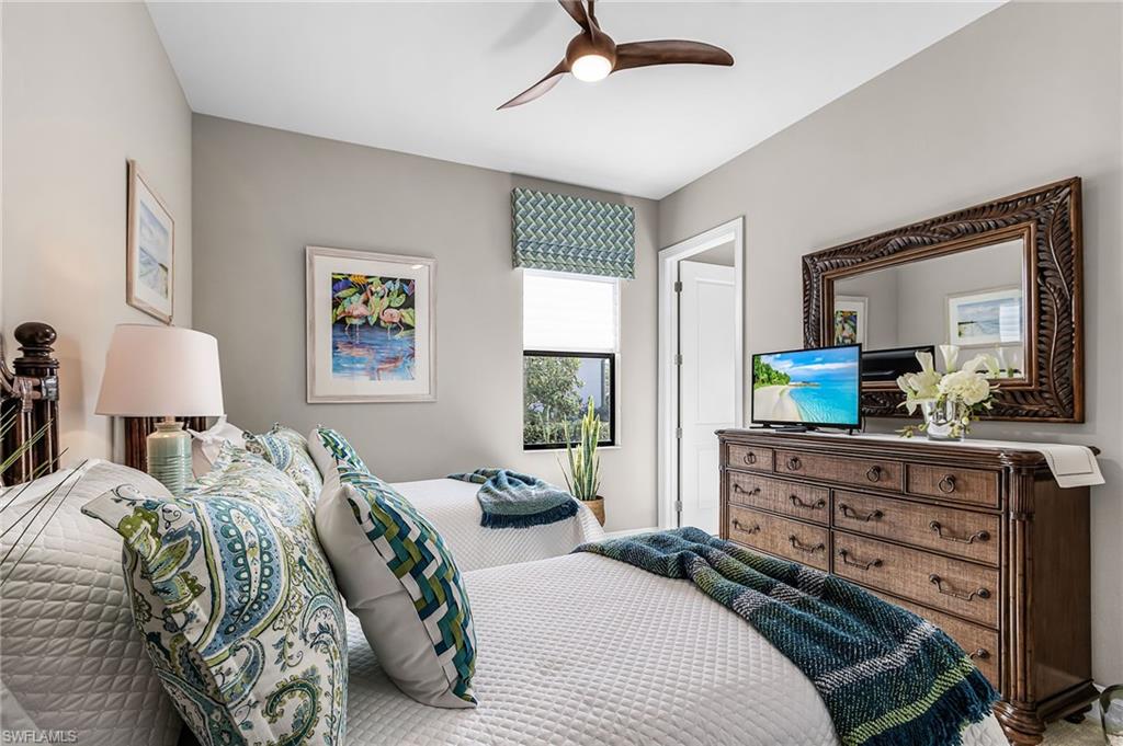 1434 Redona Way Naples, FL 34113 - Photo 14 of 47 a bedroom with a bed and a dresser