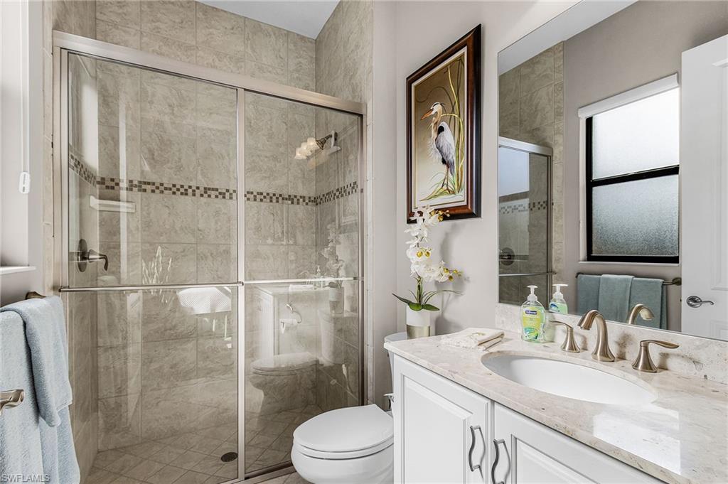 1434 Redona Way Naples, FL 34113 - Photo 15 of 47 a bathroom with a sink a toilet and shower