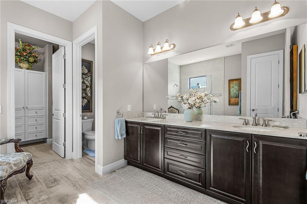 1434 Redona Way Naples, FL 34113 - Photo 18 of 47 a bathroom with a double vanity sink and a mirror
