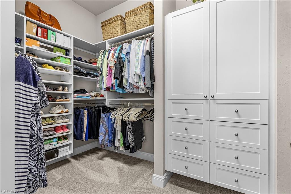 1434 Redona Way Naples, FL 34113 - Photo 20 of 47 a view of walk in closet with clothes