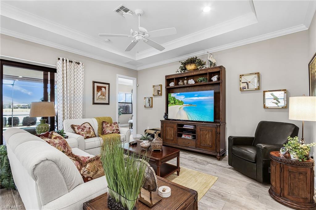 1434 Redona Way Naples, FL 34113 - Photo 27 of 47 a living room with furniture a window and a flat screen tv