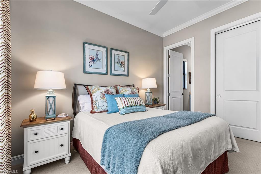 1434 Redona Way Naples, FL 34113 - Photo 6 of 47 a bedroom with a bed and a lamp on dresser
