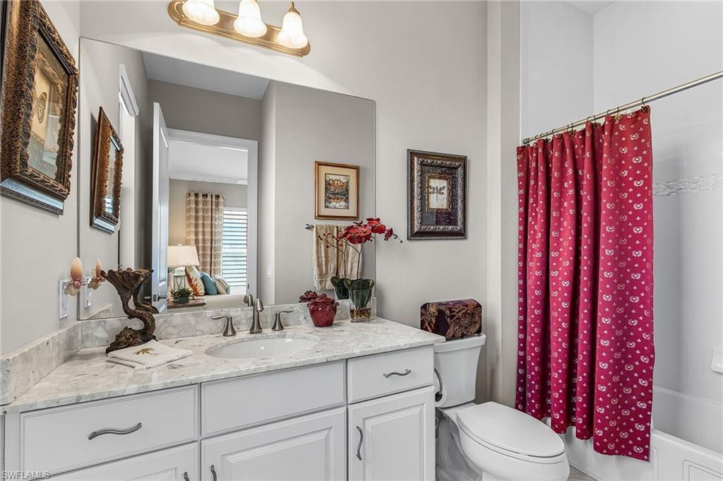 1434 Redona Way Naples, FL 34113 - Photo 7 of 47 a bathroom with a granite countertop sink mirror vanity and toilet