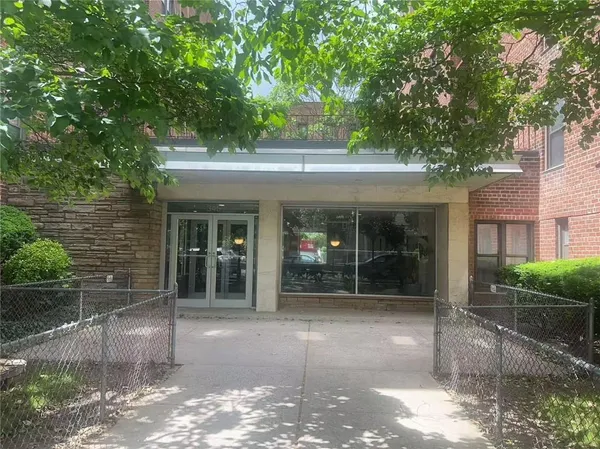 a front view of a building with a garden