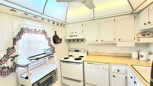 a kitchen with stainless steel appliances a sink and cabinets