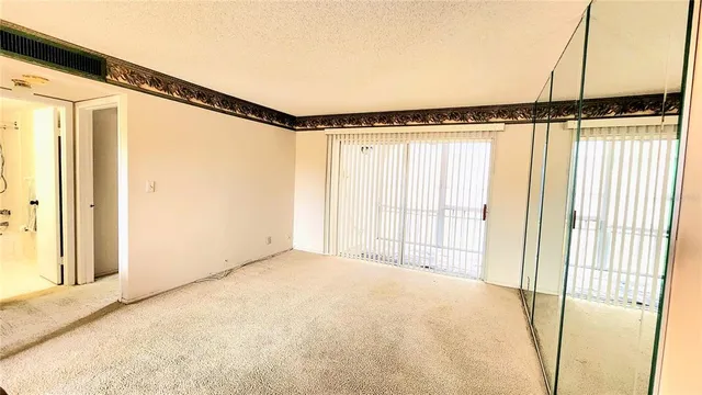 a view of a room with wooden floor and windows