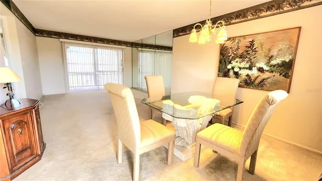 a view of a dining room with furniture and a window