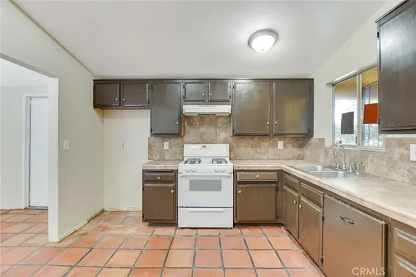 a kitchen with a stove top oven sink and cabinets