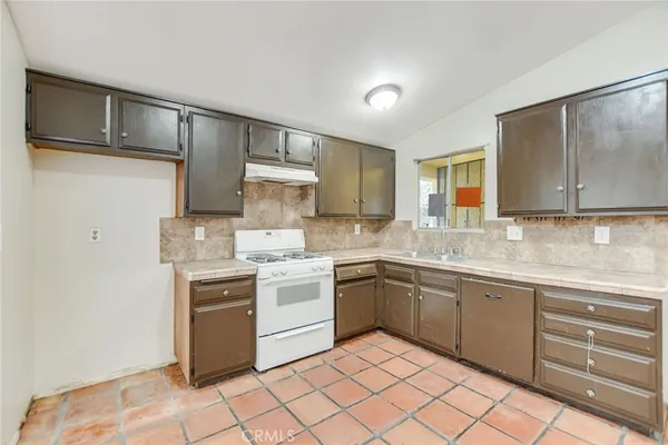a kitchen with a sink cabinets and appliances