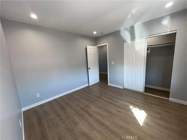 a kitchen with stainless steel appliances wooden floors and living room