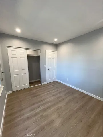 a white toilet sitting next to a bathroom sink vanity and a mirror