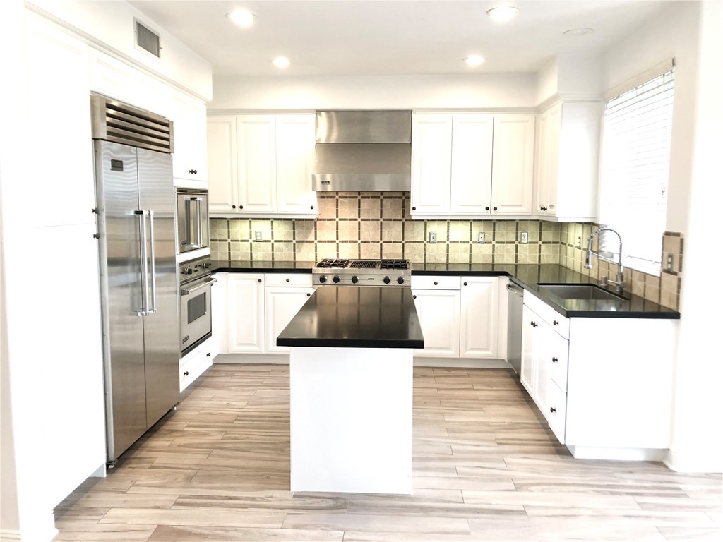 24 Tesoro Newport Coast, CA 92657 - Photo 6 of 20 a large white kitchen with wooden floor and a large window